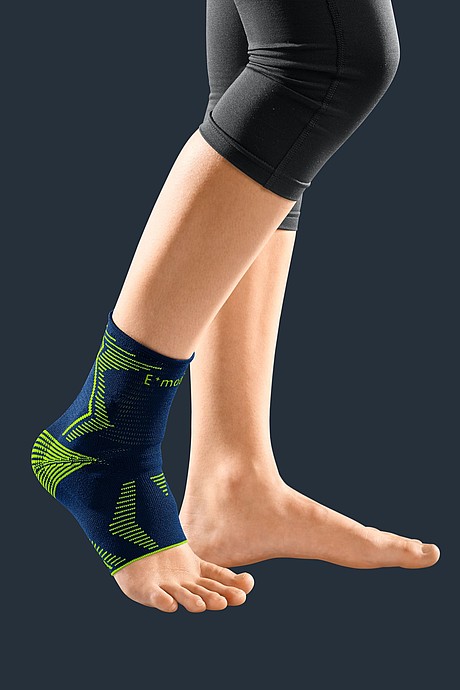 Compression ankle brace with silicone inserts